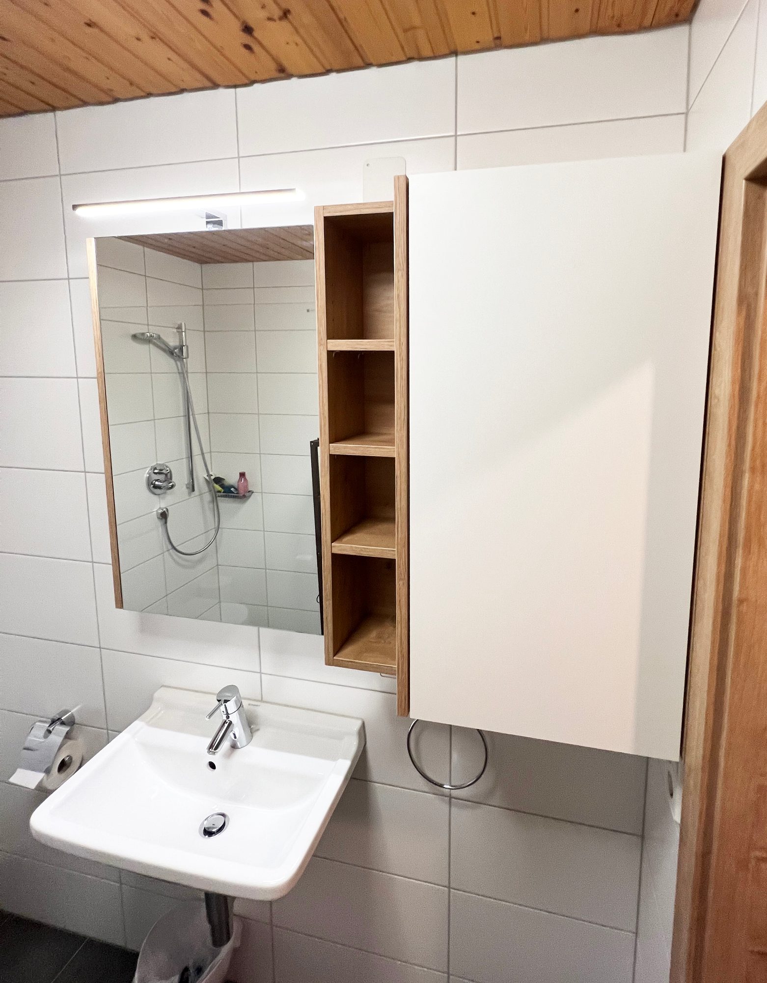 Spiegelschrank mit Holzregal über dem Waschbecken