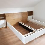 Bettrahmen vor einer Rückwand in Holzoptik mit Nischen