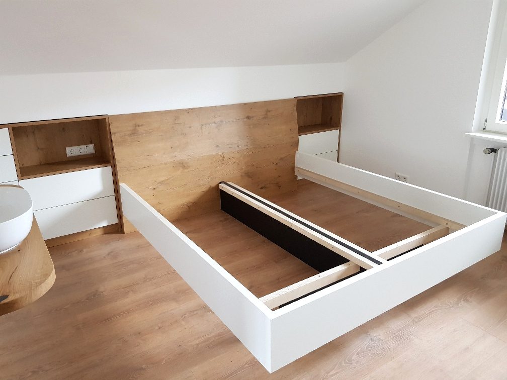 Bettrahmen vor einer Rückwand in Holzoptik mit Nischen