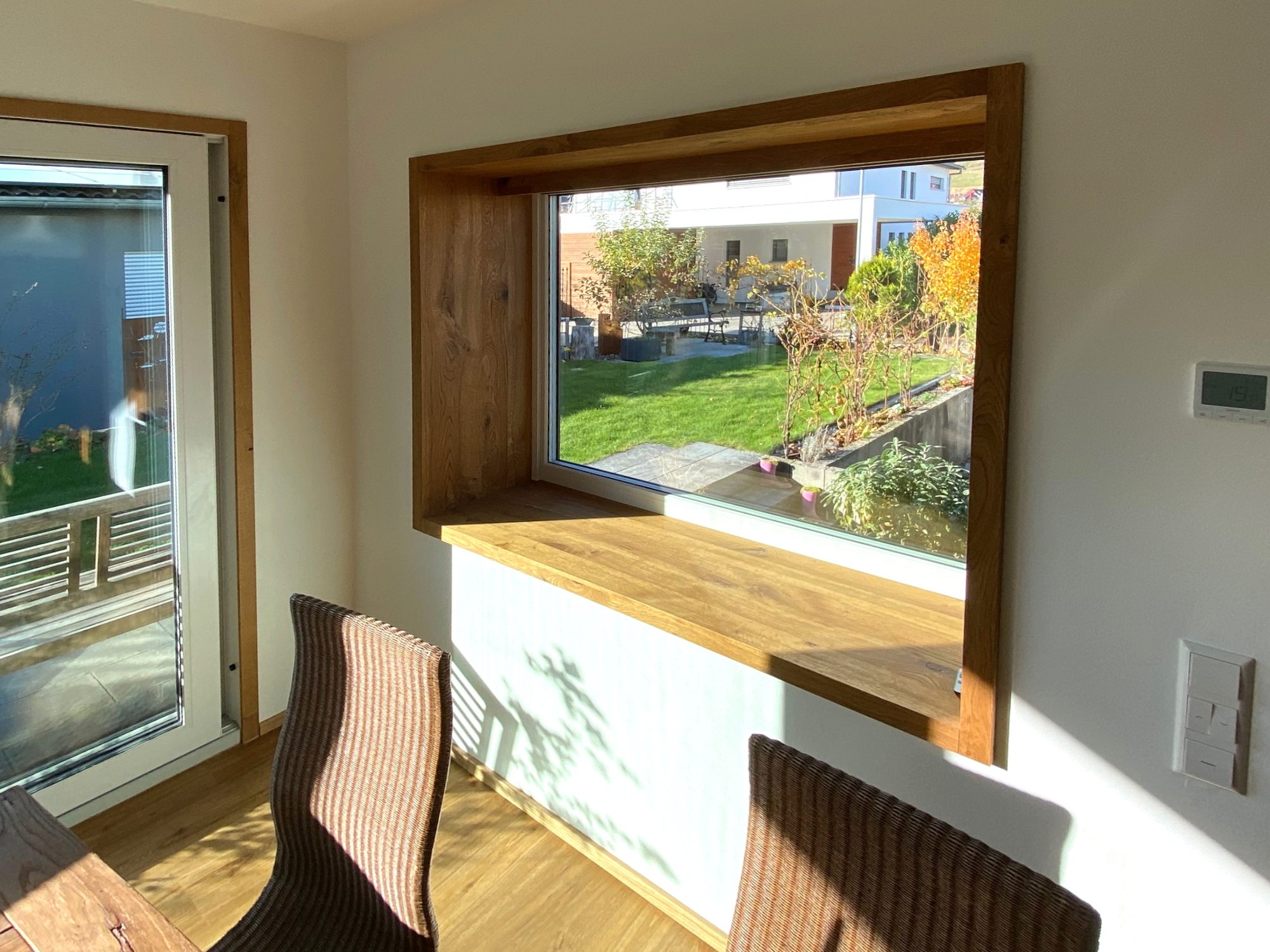 Fensterlaibung aus Holz mit Blick in den Garten